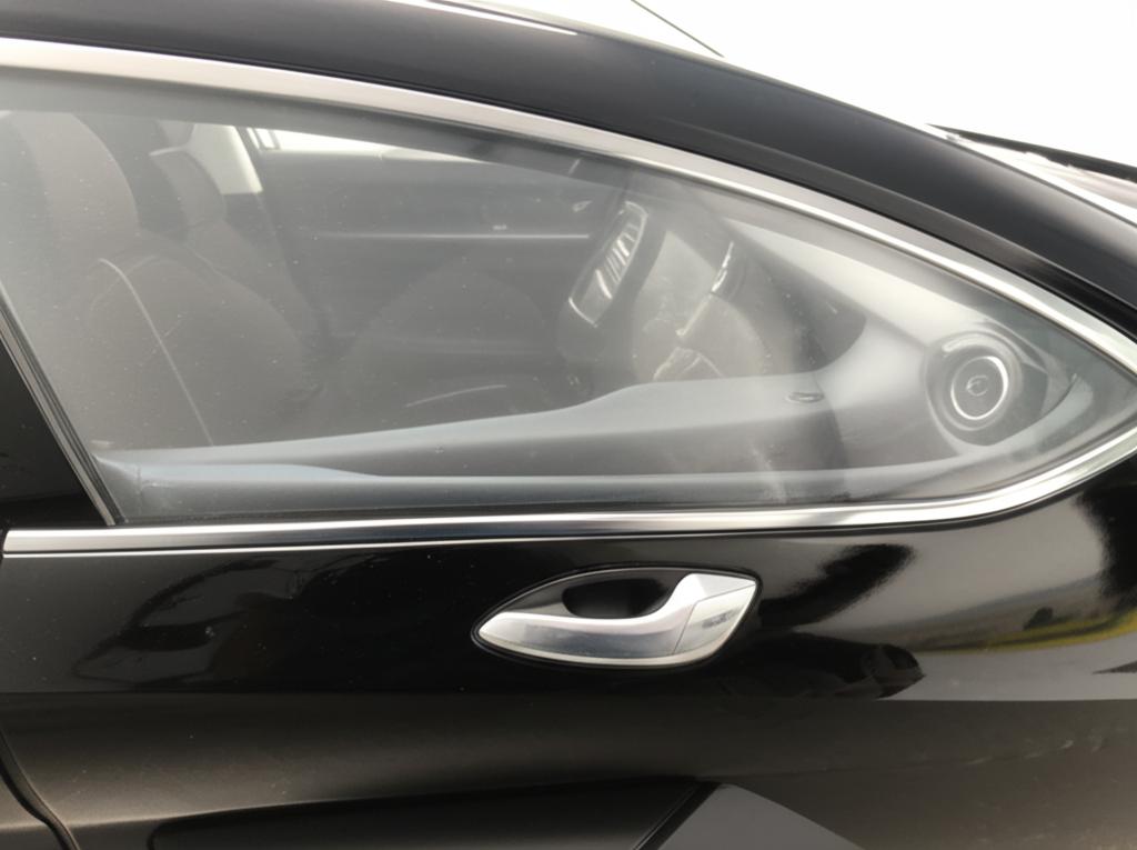 Close-up of a car panel with clear protective film